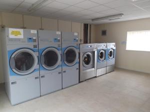 a row of washing machines in a laundry room at St Angela's Lakeside Aparthotel SALA in Sligo