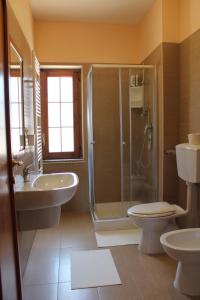 a bathroom with a shower and a toilet and a sink at B & B Il Campanile in Perdifumo +74 photos