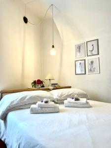 a bedroom with a white bed with two pillows on it at STECADÒ - Camera Lavanda in Dolceacqua