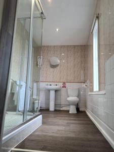 a bathroom with a toilet and a sink and a shower at Royal Albion Walton in Walton-on-the-Naze