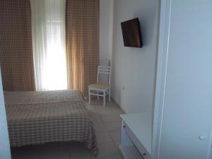 Ένα ή περισσότερα κρεβάτια σε δωμάτιο στο Milos Apartments 
