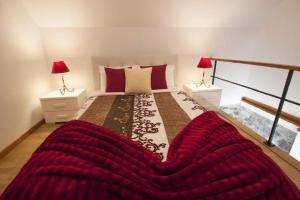 a bedroom with a large bed with two lamps at Crystal House in Calheta