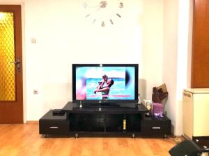 a flat screen tv sitting on a stand in a living room at Lovely Hotel & Apartment for rent in center of Gjilan in Gnjilane