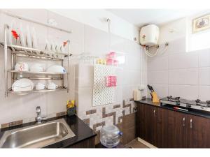 a kitchen with a sink and a counter top at BluO 1BHK Hitech City - Gym, TT, Terrace Garden, Lift in Hyderabad