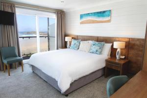 a bedroom with a bed with a view of the ocean at Esplanade Hotel in Newquay