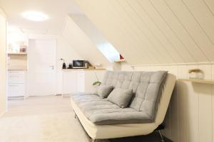 a living room with a couch in a attic at Pension Adel in Český Krumlov