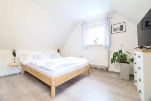a bedroom with a bed and a window at Pension Adel in Český Krumlov