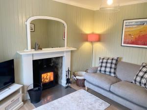 a living room with a couch and a fireplace at Shepherd Moon in Talmine