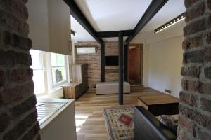 a living room with a couch and a brick wall at Coskun House in Istanbul