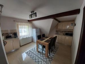 a kitchen with a table and chairs in a room at Apartament Matei in Braşov