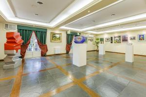 a large room with paintings and art on display at Tri Hotel Le Chateau in Gramado