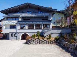 a large white building with a balcony at Pension Abendruh in Kaprun