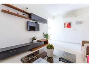 A television and/or entertainment centre at BluO 2BHK Hitech City - Gym, Terrace Garden, Lift