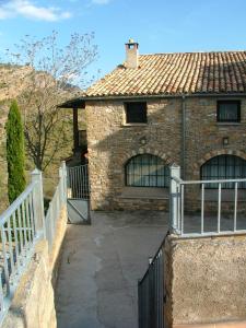 a brick house with a gate in front of it at Rectoria de Claverol in Claverol