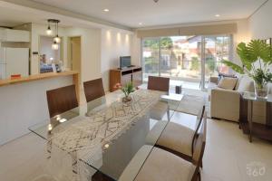 a dining room and living room with a glass table at N4A2 - New, Nice, for Long and Short Stay in Asuncion