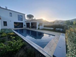a swimming pool in front of a house at Onze Villa in Provence, Mont Ventoux, New Luxury Villa, Private Pool, Stunning views, Outdoor Kitchen, Big Green Egg in Malaucène