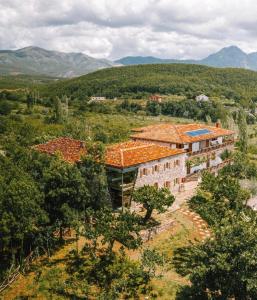 an aerial view of a building with mountains in the background at Mrizi i Zanave Agroturizëm in Lezhë