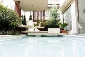 a swimming pool in the middle of a house at City Loft Hotel in Patra