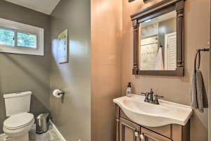 a bathroom with a sink and a toilet and a mirror at Lakefront High Point House with Furnished Deck! in High Point +25 photos