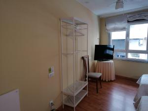 a room with a room with a tv and a table at Cuatro Caminos in Sarria