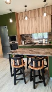 a kitchen with a large marble table and two stools at Апартаменти поруч із Софіївським парком Dolce Vita in Uman