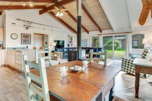 a kitchen and living room with a wooden table and chairs at Dune Grass Cottage in Copalis Beach +24 photos