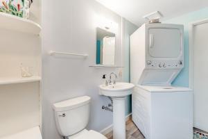 a white bathroom with a sink and a toilet at Dune Grass Cottage in Copalis Beach