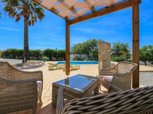 a patio with a table and chairs and a pool at V3, Villa Belo Horizonte near Beach, Albufeira in Albufeira