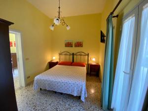 a bedroom with a bed with red pillows on it at b&b verde salento in Galatone