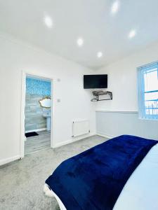 a bedroom with a bed and a tv on the wall at Monopoly Holiday Home in Blackpool