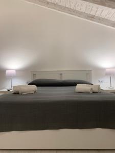 En eller flere senge i et værelse på San Paolo Rooms