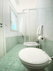a white bathroom with a toilet and a sink at b&b verde salento in Galatone