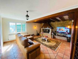 a living room with a couch and a fireplace at SagastiEnea Villa con Piscina y Tenis en la Rioja in Samaniego