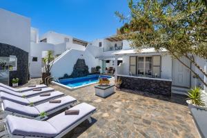 a patio with lounge chairs and a swimming pool at Plastiras Rooms in Fira