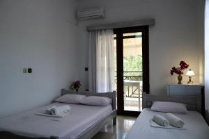 Posteľ alebo postele v izbe v ubytovaní Hotel Akropolis