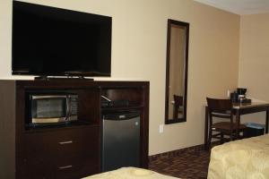 a hotel room with a microwave and a television at CHINOOK INN in Rocky Mountain House