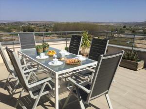 a table and chairs on a balcony with a view at Tudela Mirador de Bardenas in Tudela