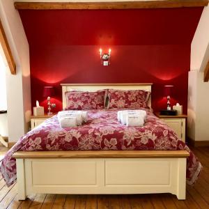 a red bedroom with a white bed with red walls at Navy & Co in Houesville
