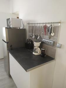 a kitchen with a counter with utensils on it at appartement 8 couchages 3 chambres in Sens
