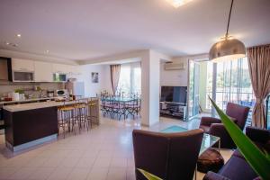 a large kitchen and living room with chairs and tables at MNG Holiday Yassen Apartments in Sunny Beach