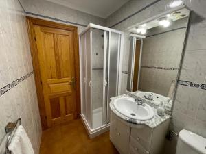 a bathroom with a sink and a shower and a mirror at Apartamentos rurales La Casa Vieja De Alceda in Alceda +124 photos