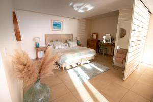 a bedroom with a bed and a vase on the floor at At The Beach Rooms in Portstewart