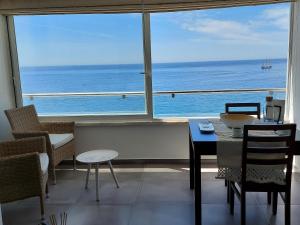 a dining room with a view of the ocean at Acqua Marine in Sesimbra