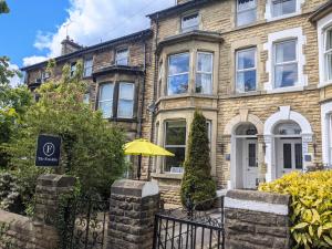 a house with a yellow umbrella in front of it at The Franklin in Harrogate
