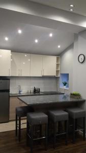 a kitchen with a large counter with stools in it at Apartmani Trklja in Trebinje