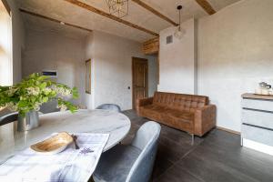 a living room with a table and a couch at Vija apartment Kuldīga in Kuldīga