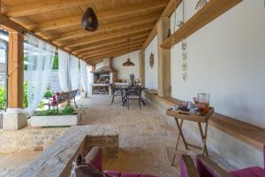 a living room with a stone floor and wooden ceiling at Casa Jagoda in Višnjan