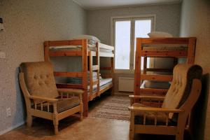 a room with two bunk beds and two chairs at Pärus Fors in Lapväärtti