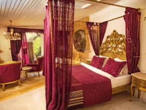 a bedroom with a canopy bed with red curtains at Lethe Exclusive Hotel in Ağva +64 photos