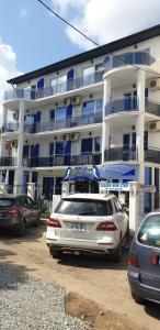a white car parked in front of a building at Vila Blue Lagoon in Eforie Nord